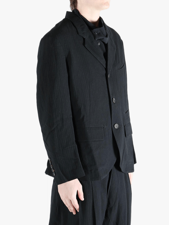 black jackets-coats worn by a person, showing the jackets-coats fit