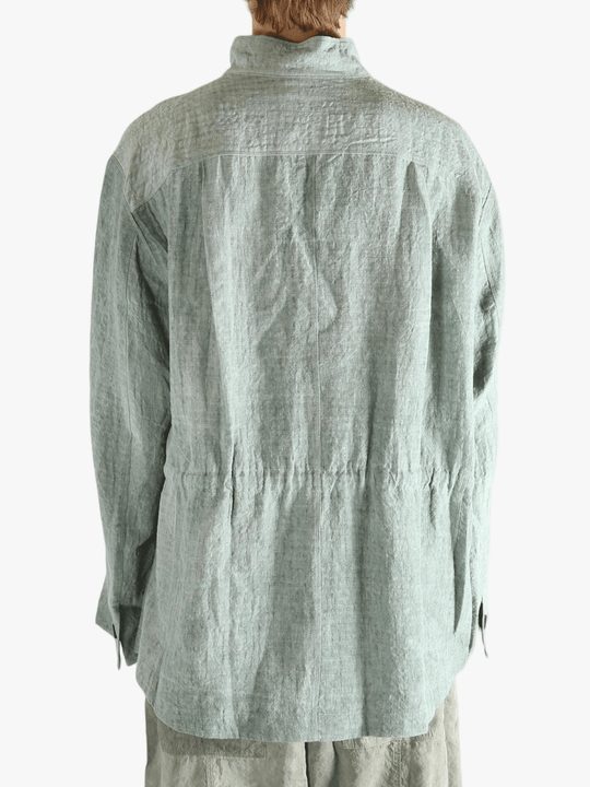 Green shirt worn by a person, showing the shirt's fit