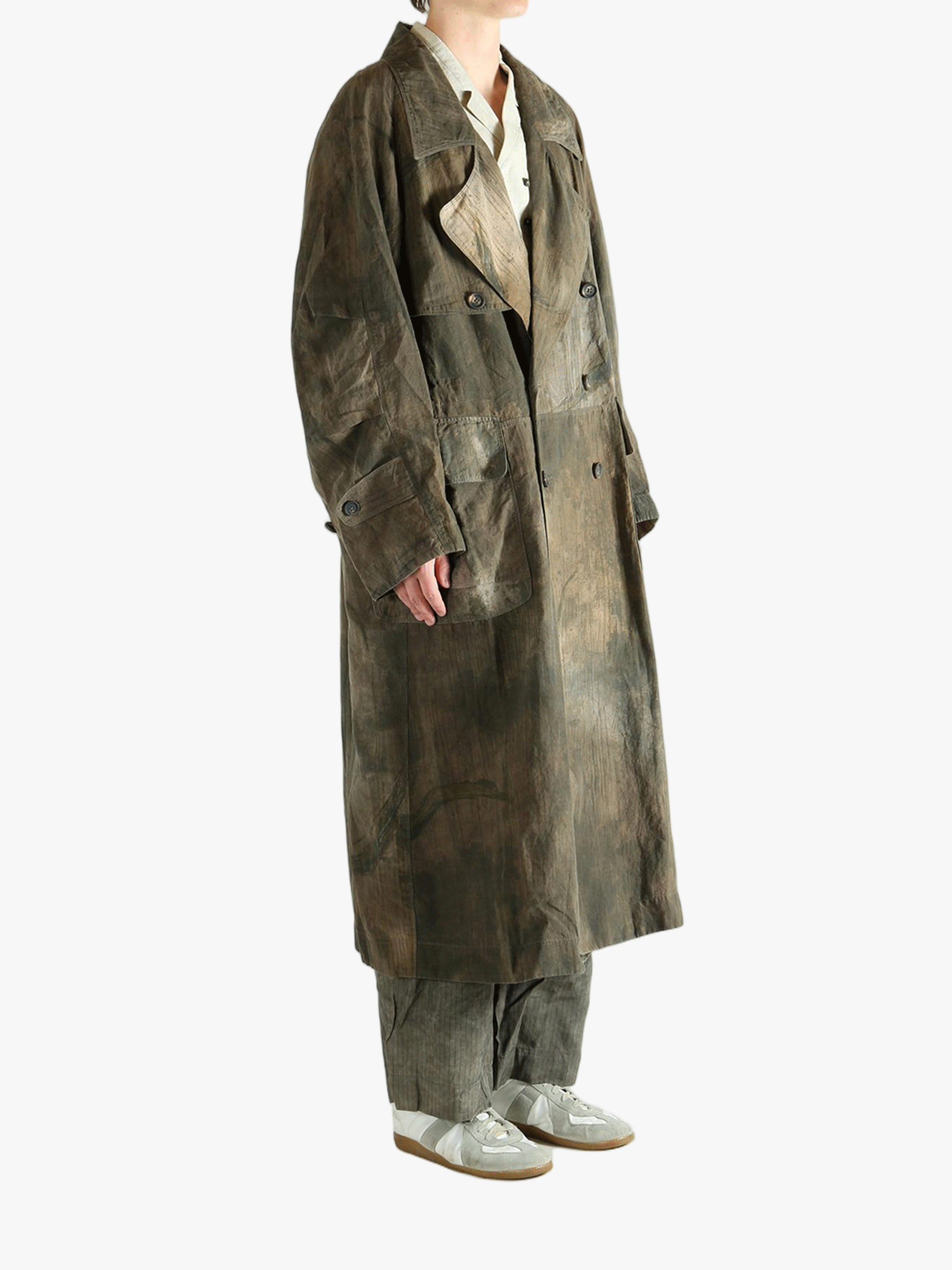 Green coat worn by a person, showing the coat's fit