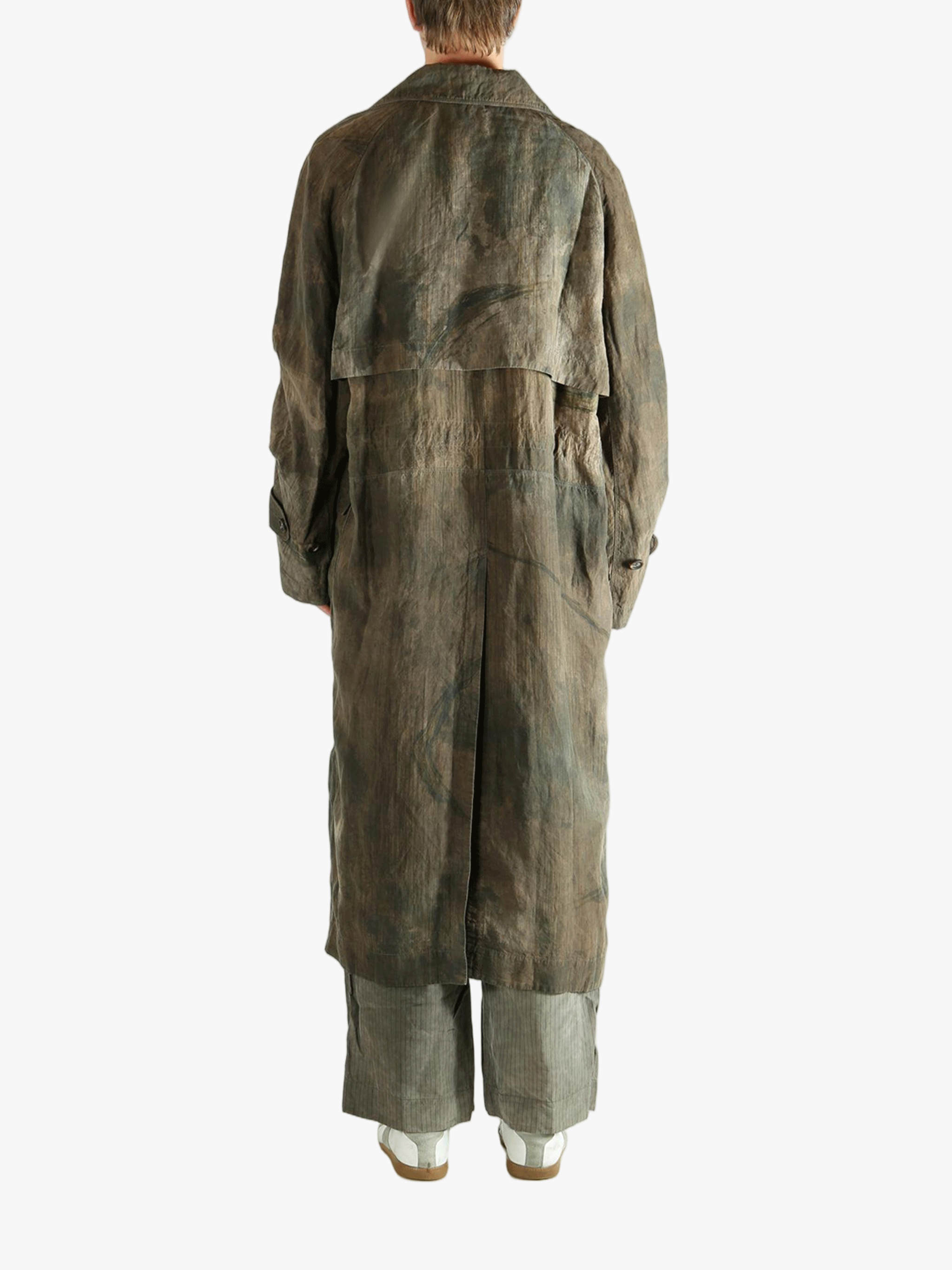 Green coat worn by a person, showing the coat's fit