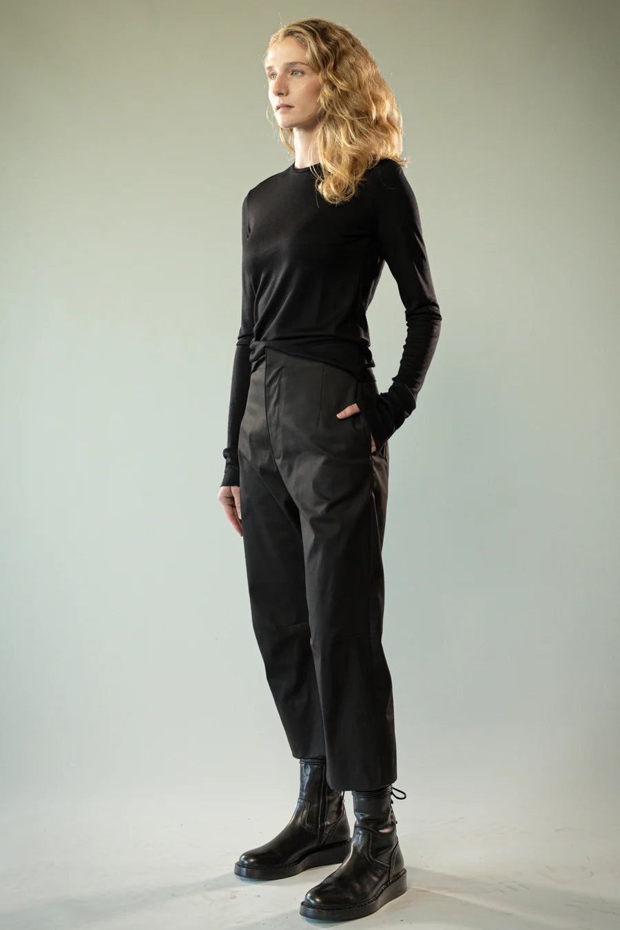 Black knitwear worn by a person, showing the knitwear's fit