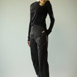 Black knitwear worn by a person, showing the knitwear's fit