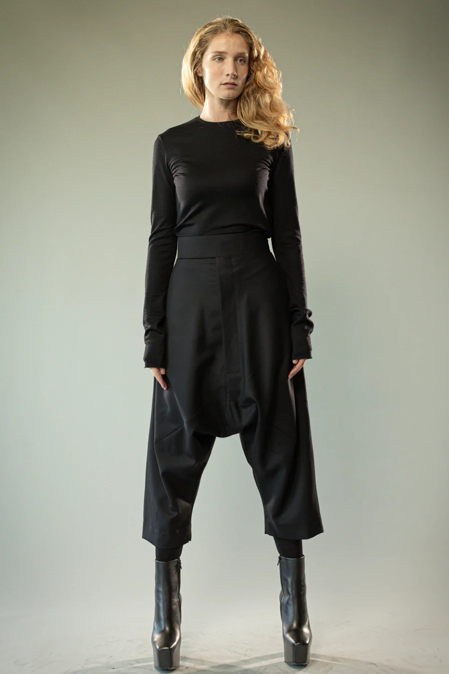 Black pants worn by a person, showing the pants' fit