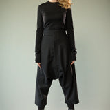 Black pants worn by a person, showing the pants' fit