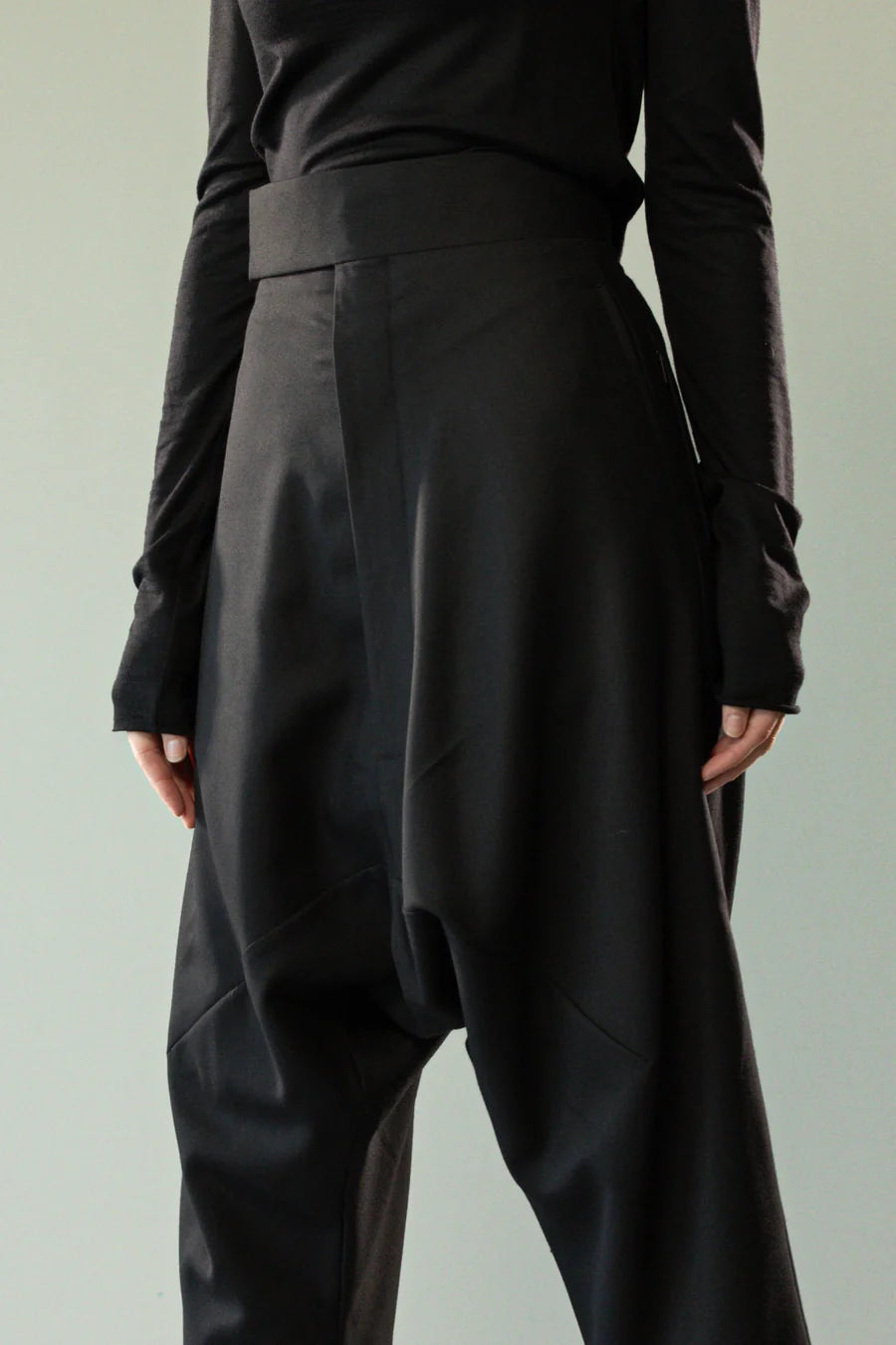 Close up of black pants, showing texture of the wool twill fabric
