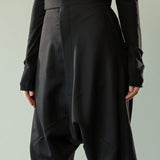 Close up of black pants, showing texture of the wool twill fabric