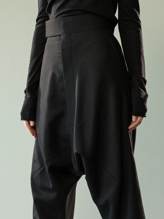 Close up of black pants, showing texture of the wool twill fabric