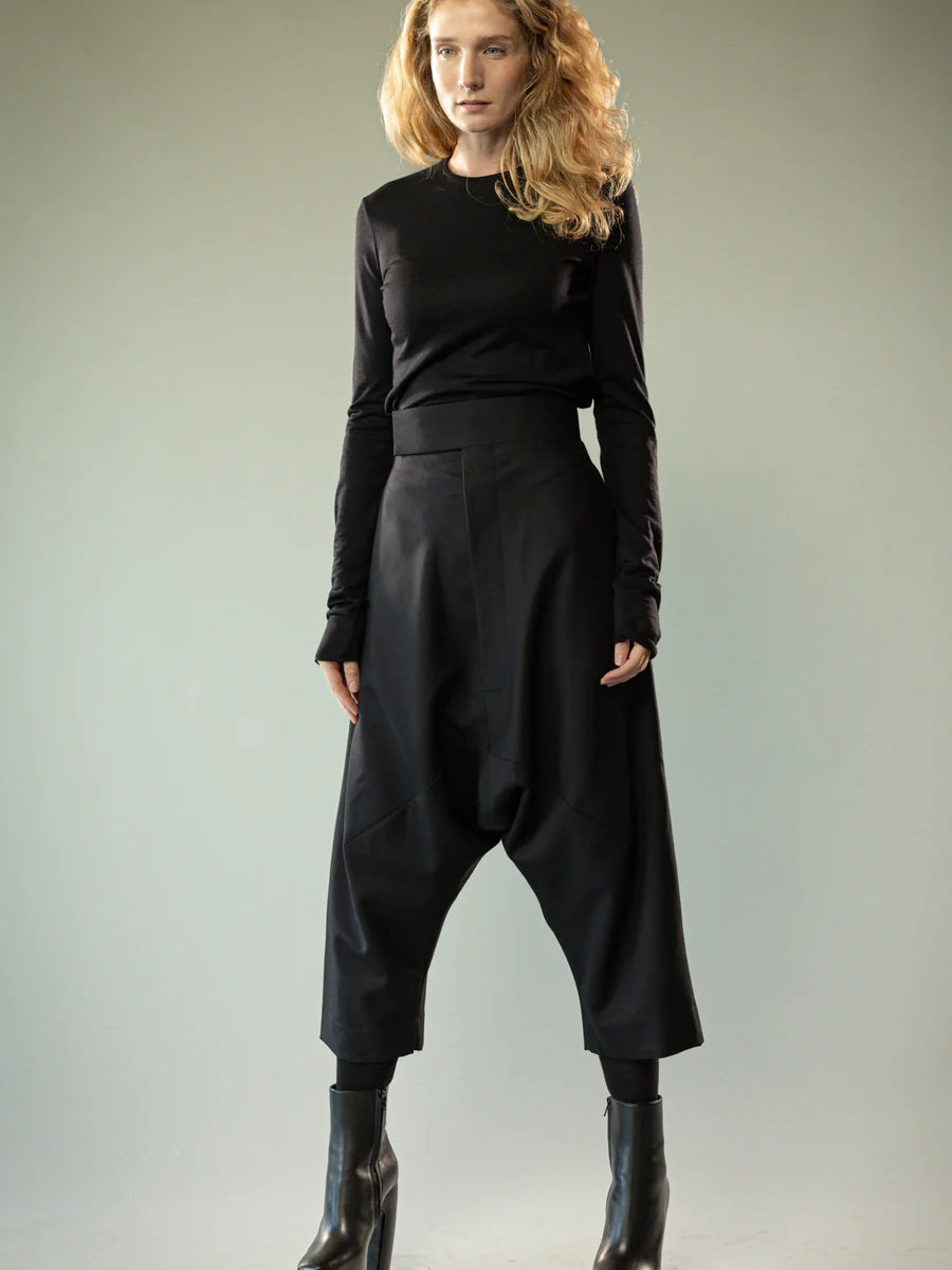 Black knitwear worn by a person, showing the knitwear's fit