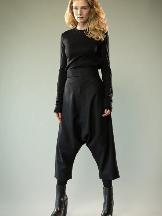 Black knitwear worn by a person, showing the knitwear's fit