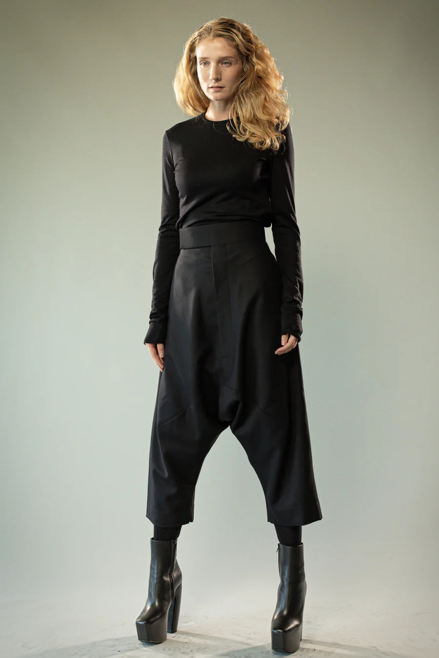 Black pants worn by a person, showing the pants' fit