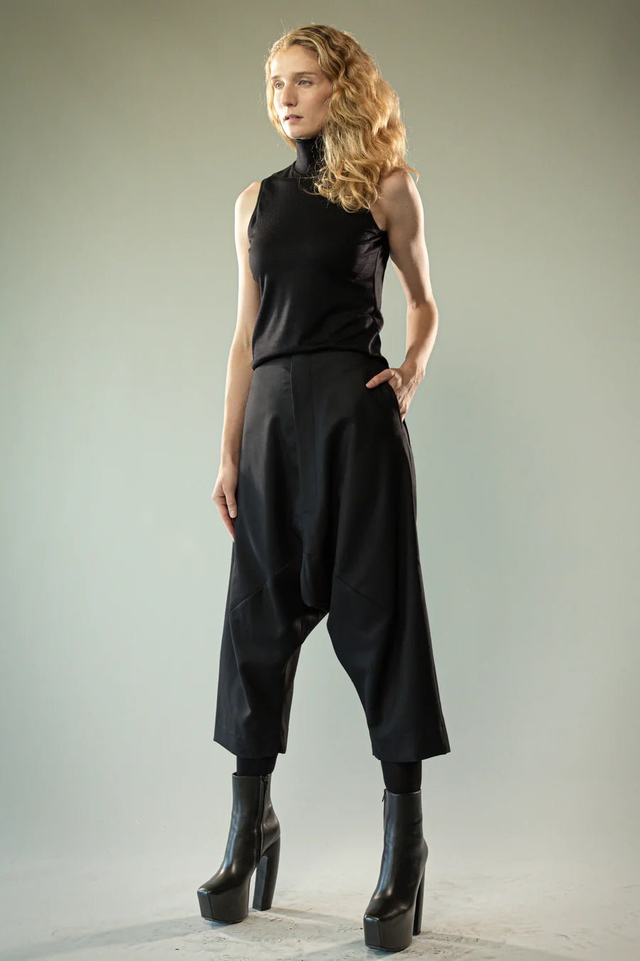 Black pants worn by a person, showing the pants' fit