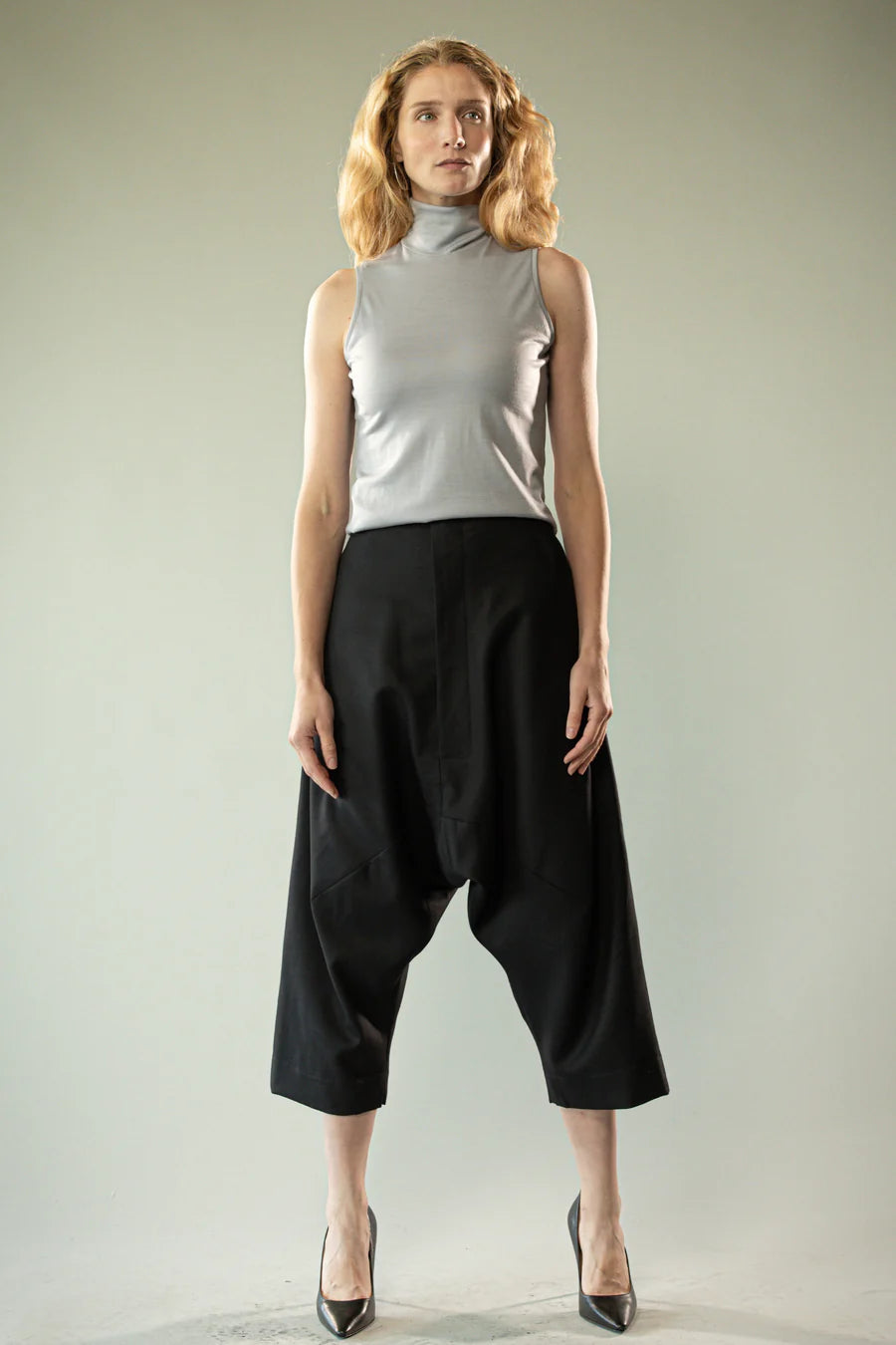 Black pants worn by a person, showing the pants' fit