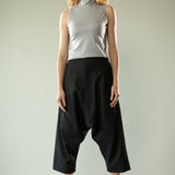 Black pants worn by a person, showing the pants' fit