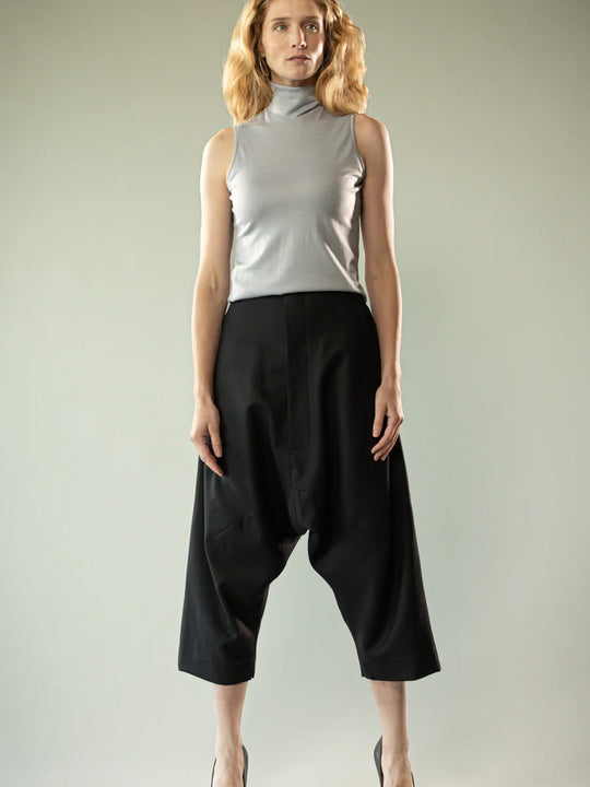 Black pants worn by a person, showing the pants' fit