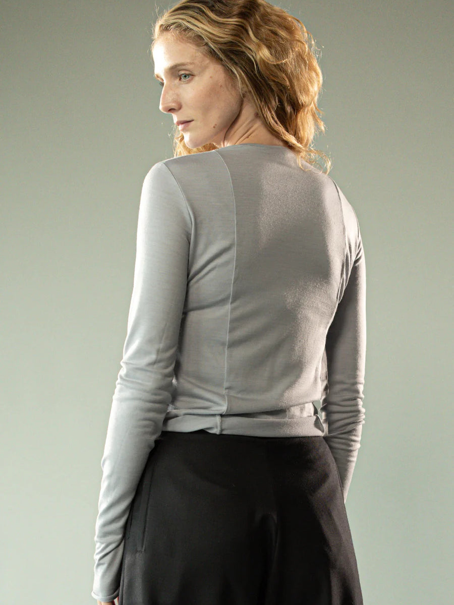 Grey knitwear worn by a person, showing the knitwear's fit