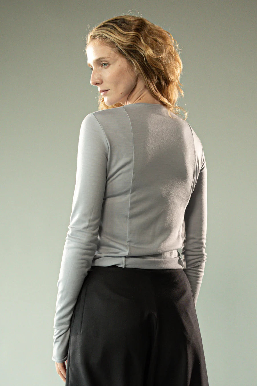Grey knitwear worn by a person, showing the knitwear's fit