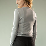 Grey knitwear worn by a person, showing the knitwear's fit