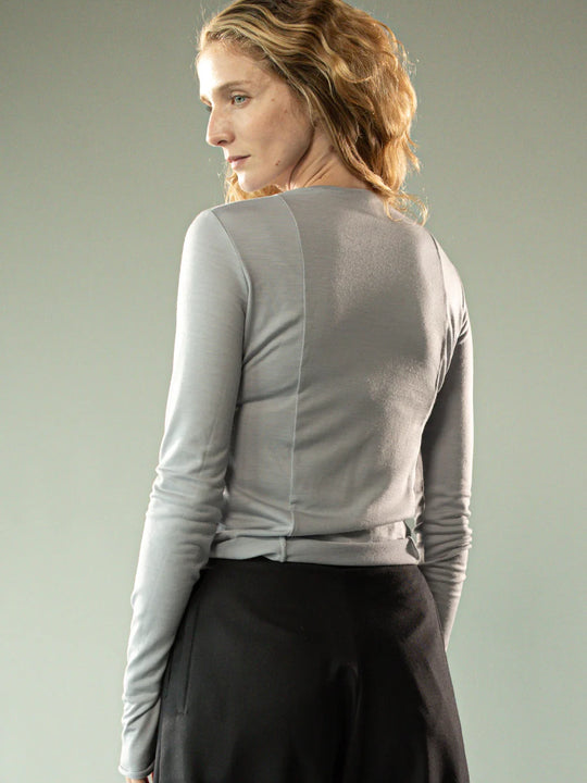 Grey knitwear worn by a person, showing the knitwear's fit
