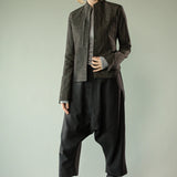 Black pants worn by a person, showing the pants' fit