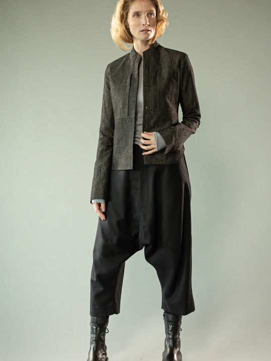 Black pants worn by a person, showing the pants' fit