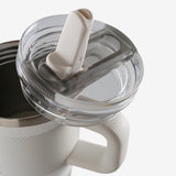 Close up of white tumbler, showing texture of the stainless steel fabric