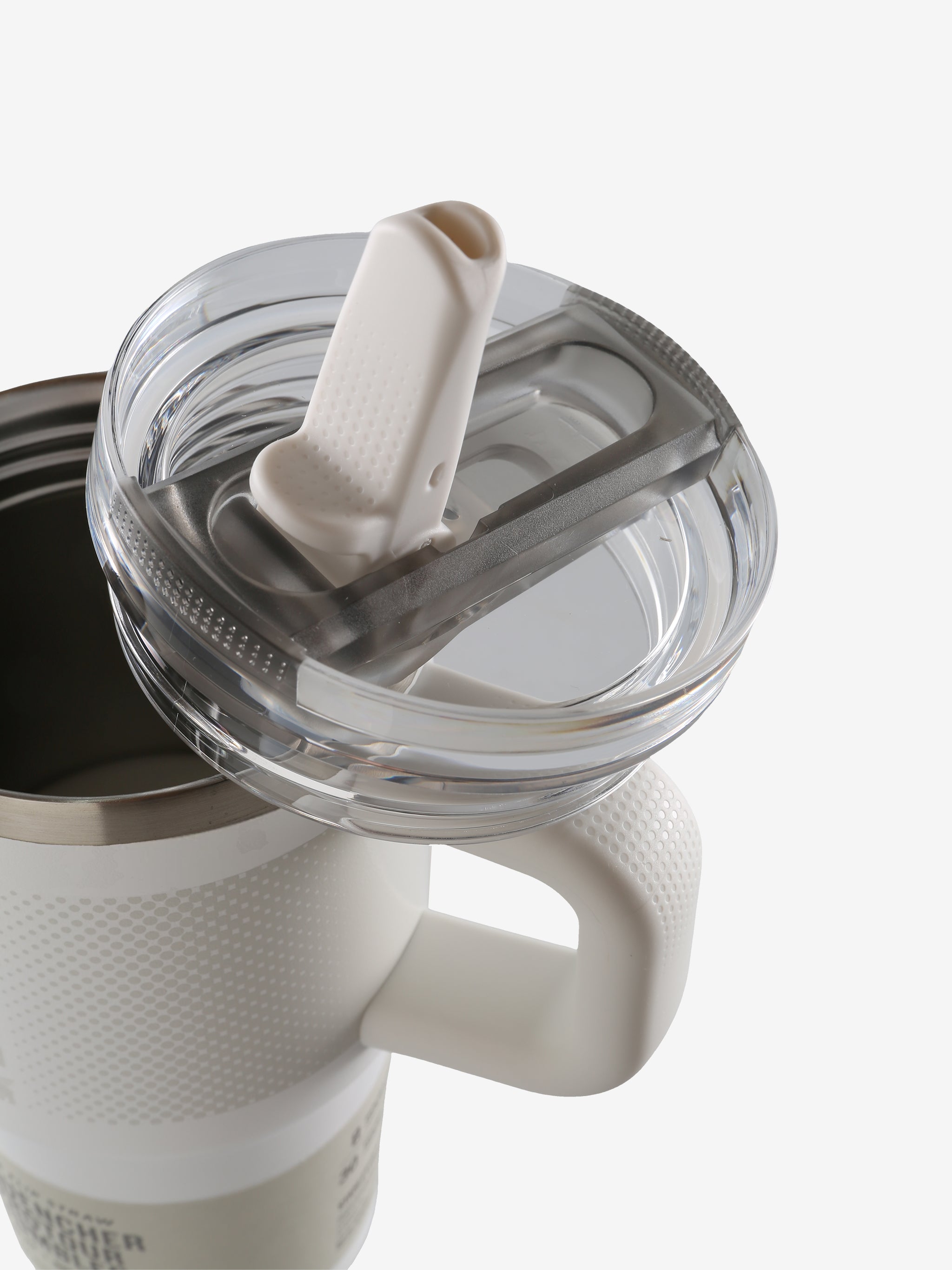 Close up of white tumbler, showing texture of the stainless steel fabric