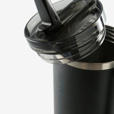 Close up of black tumbler, showing texture of the stainless steel fabric