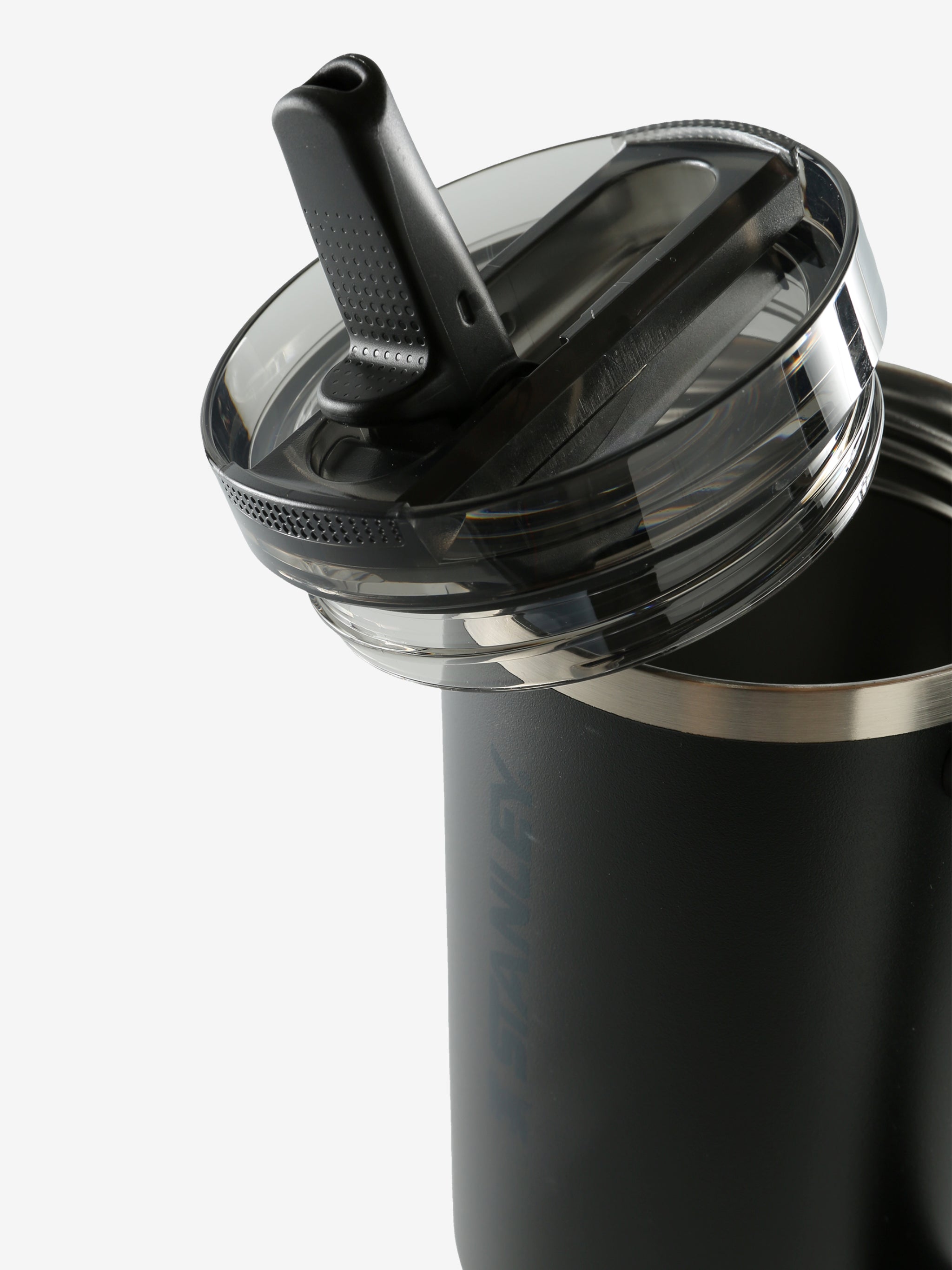 Close up of black tumbler, showing texture of the stainless steel fabric