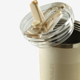 Close up of tan tumbler, showing texture of the stainless steel fabric