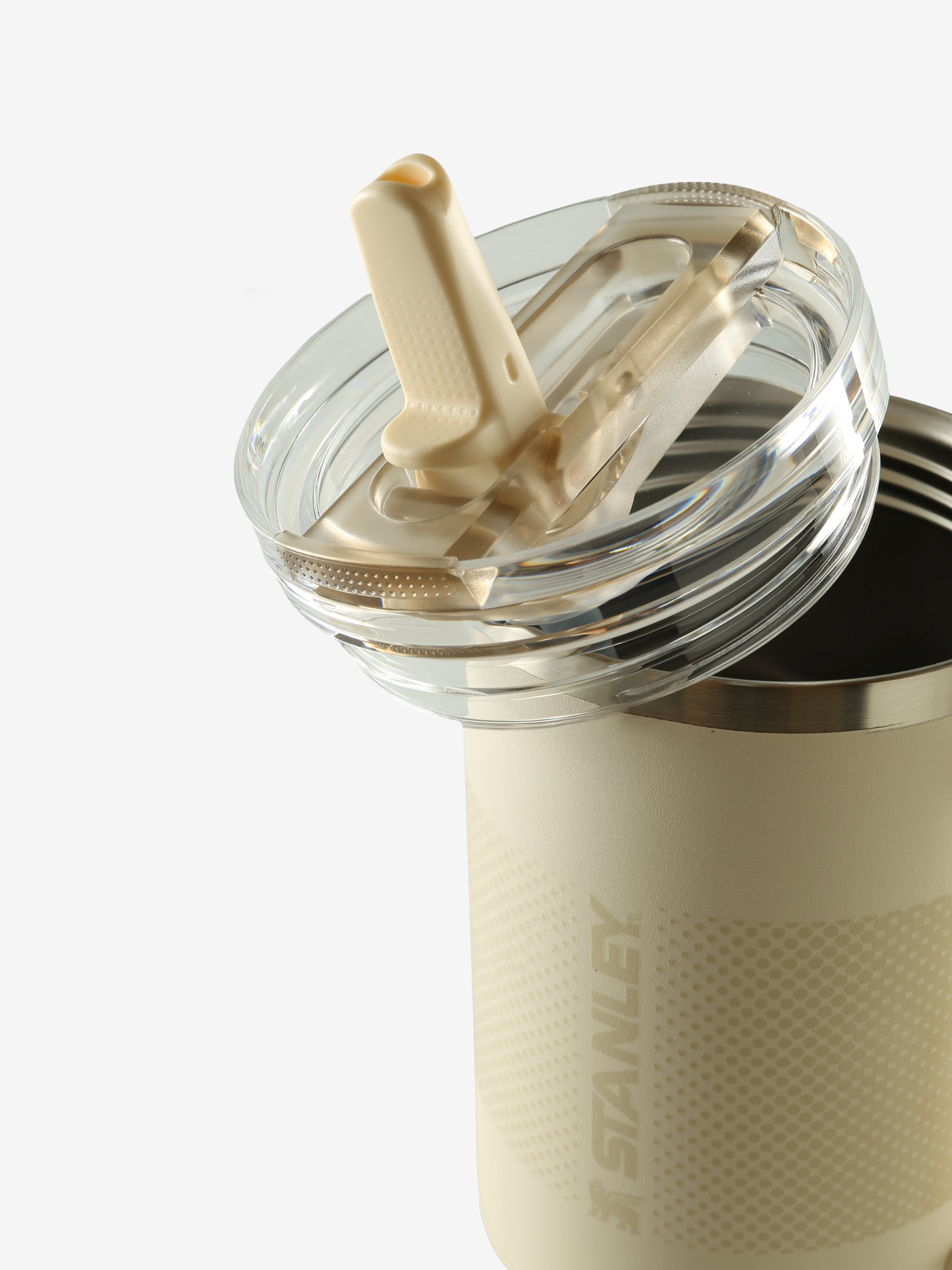 Close up of tan tumbler, showing texture of the stainless steel fabric