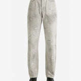 White jeans worn by a person, showing the jeans fit