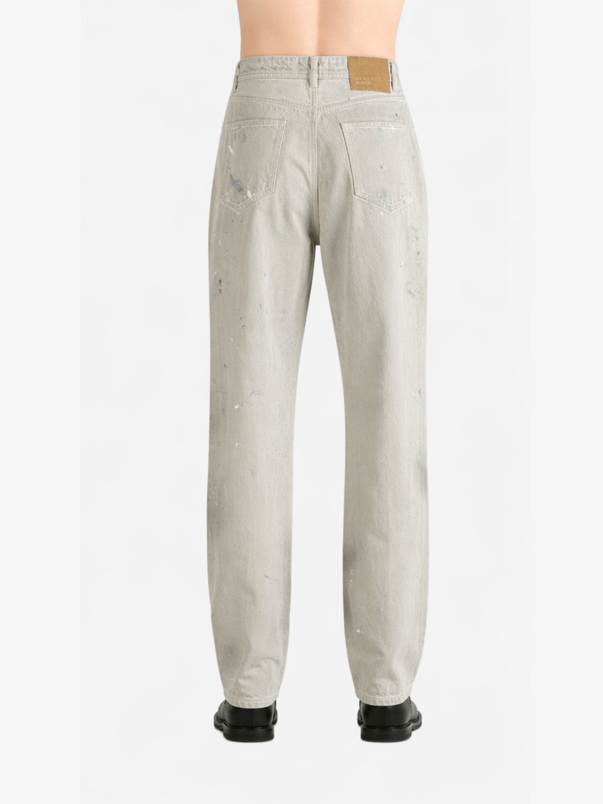 White jeans worn by a person, back view