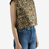 Brown top worn by a person, showing the top's fit