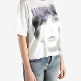 White t-shirt worn by a person, showing the shirt's fit