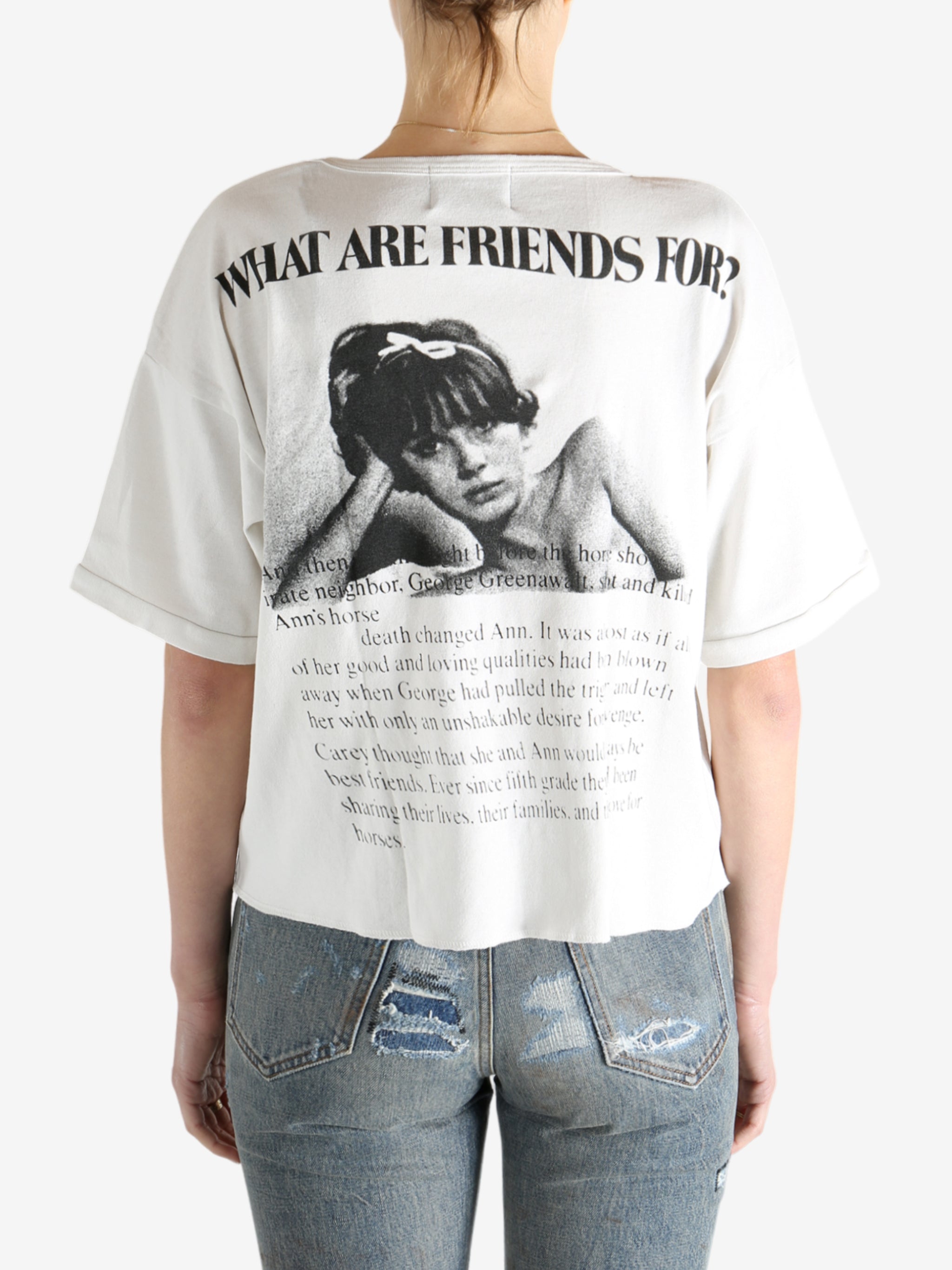 White t-shirt worn by a person, showing the shirt's fit