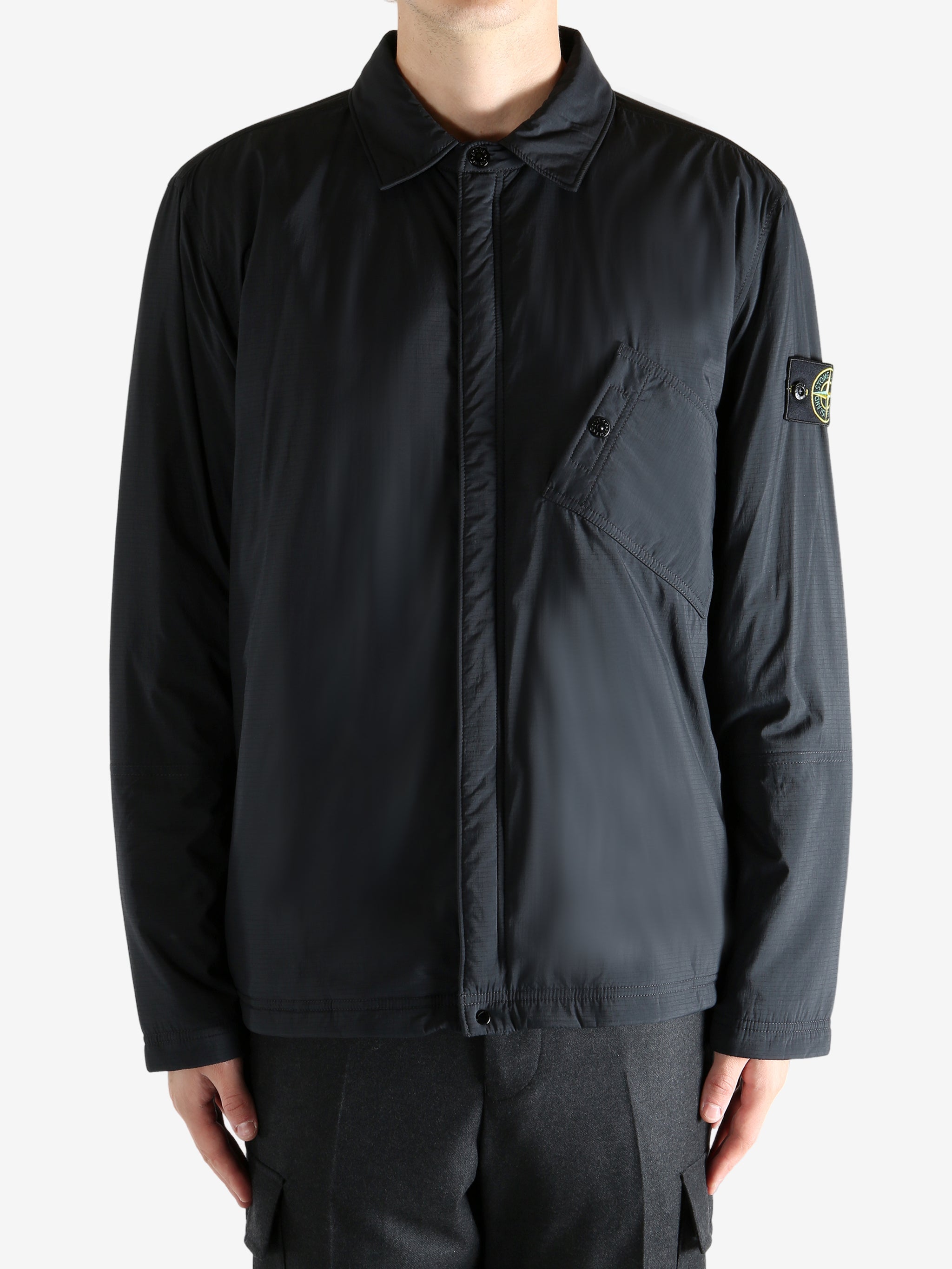 Black striped shirts worn by a person, showing the shirt's fit