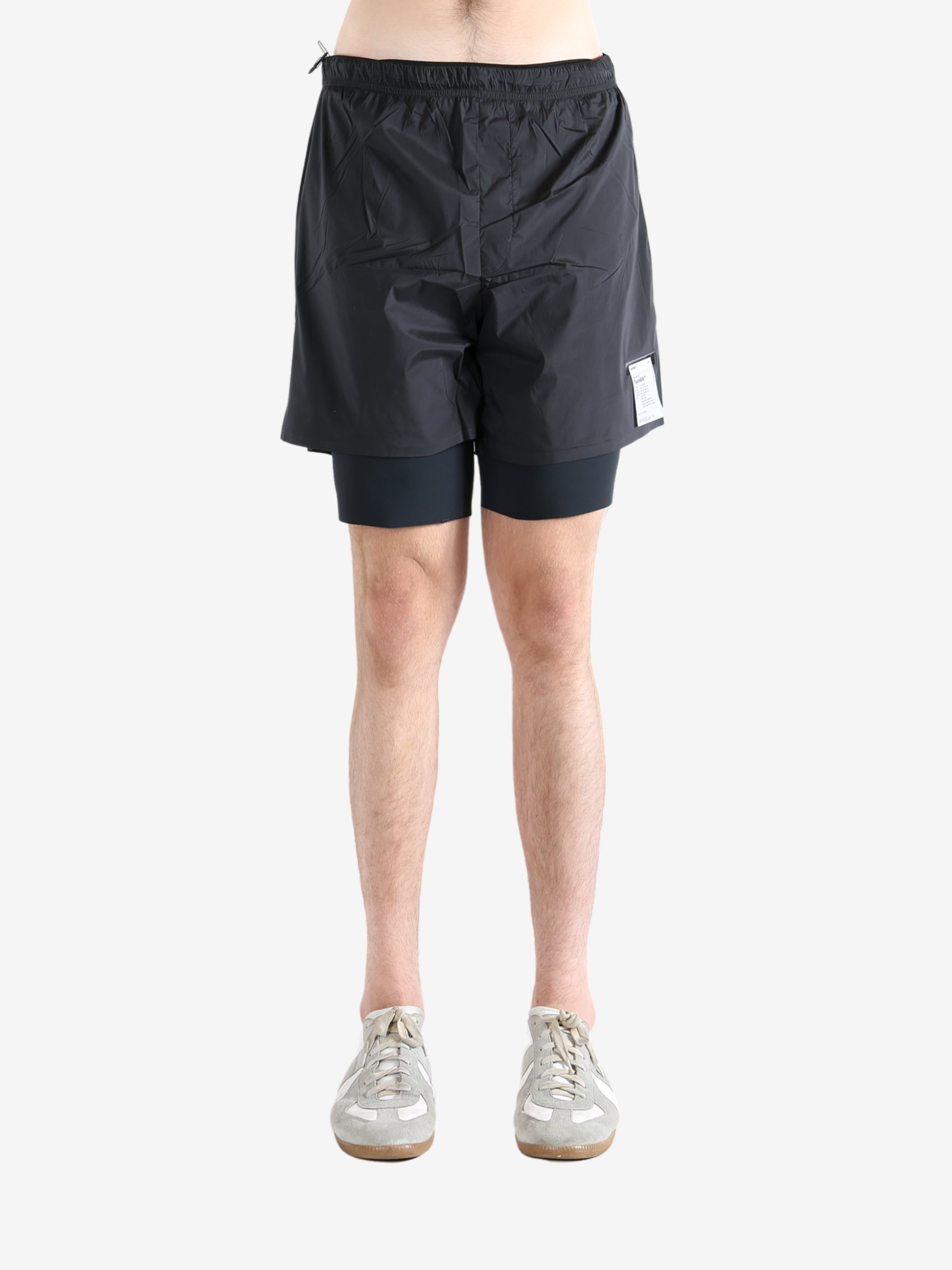 Black shorts worn by a person, showing the shorts fit