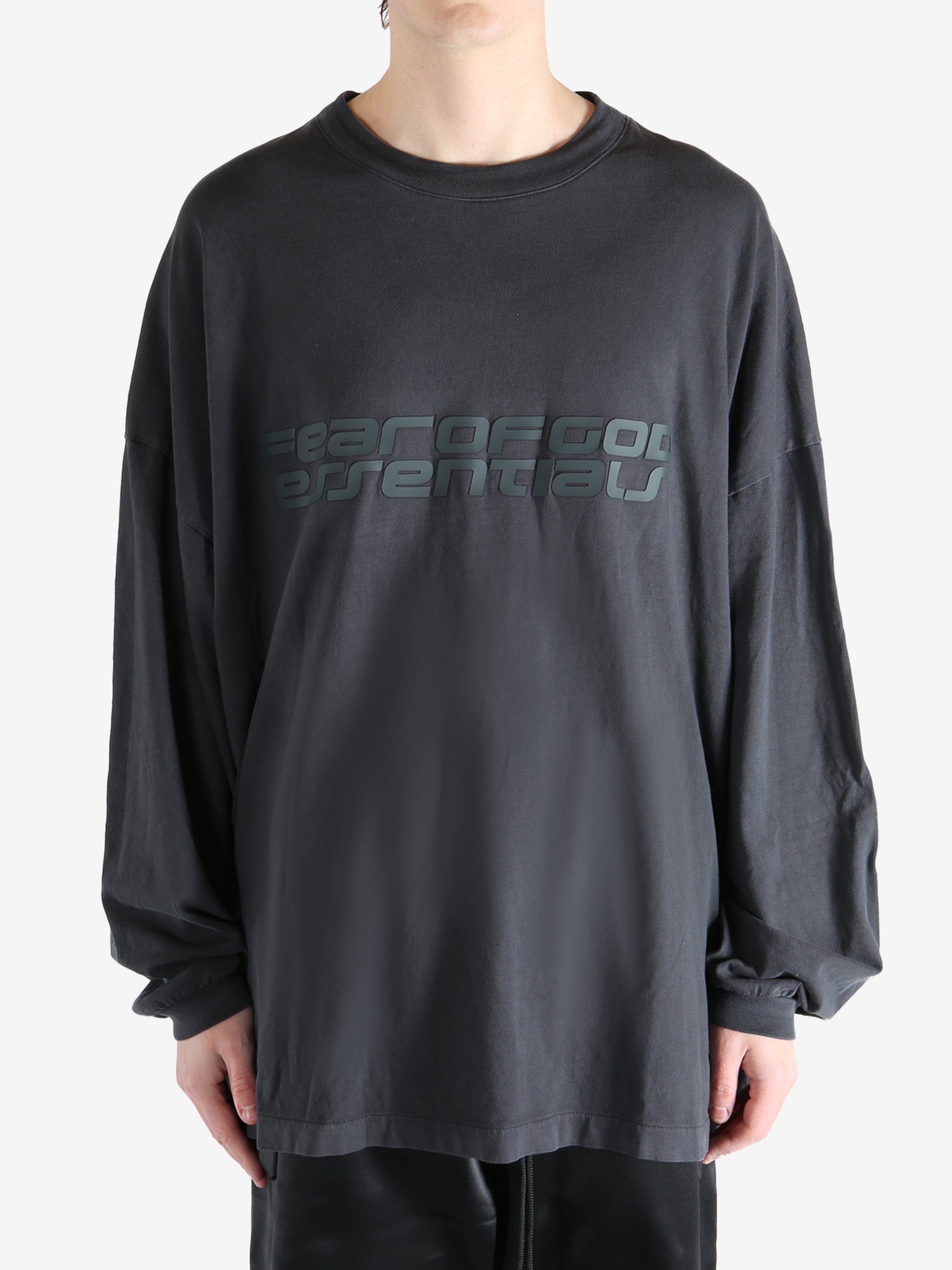 Black shirt worn by a person, showing the shirt's fit