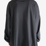 Black shirt worn by a person, showing the shirt's fit