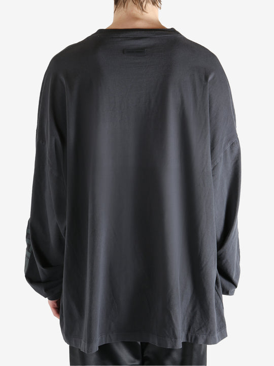 Black shirt worn by a person, showing the shirt's fit