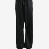 Black pants worn by a person, showing the pants fit