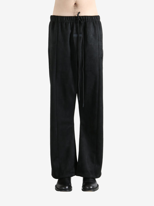 Black pants worn by a person, showing the pants fit