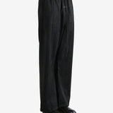 Black pants worn by a person, showing the pants fit