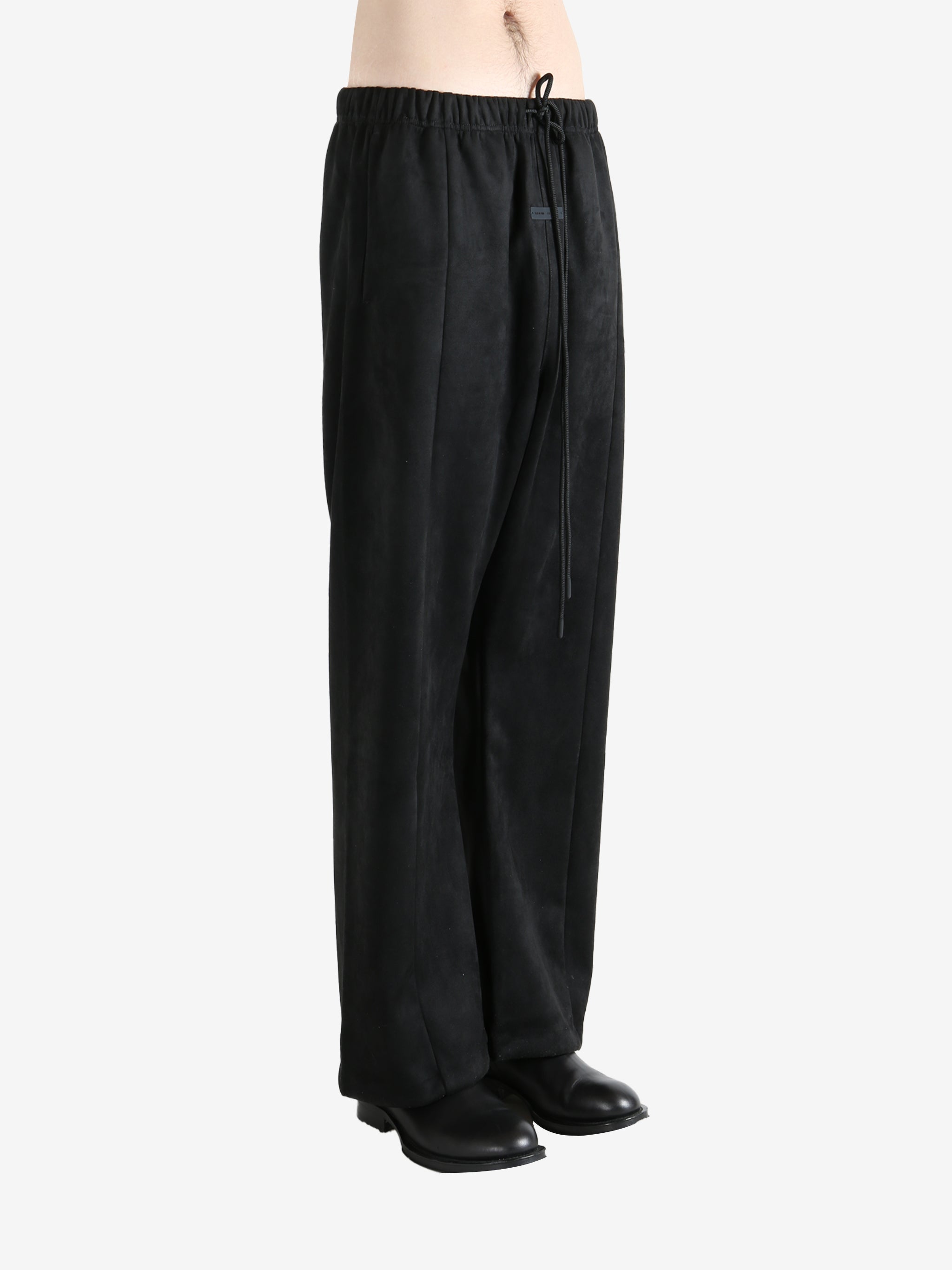 Black pants worn by a person, showing the pants fit