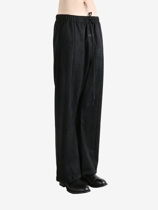 Black pants worn by a person, showing the pants fit