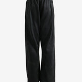 Black pants worn by a person, showing the pants fit