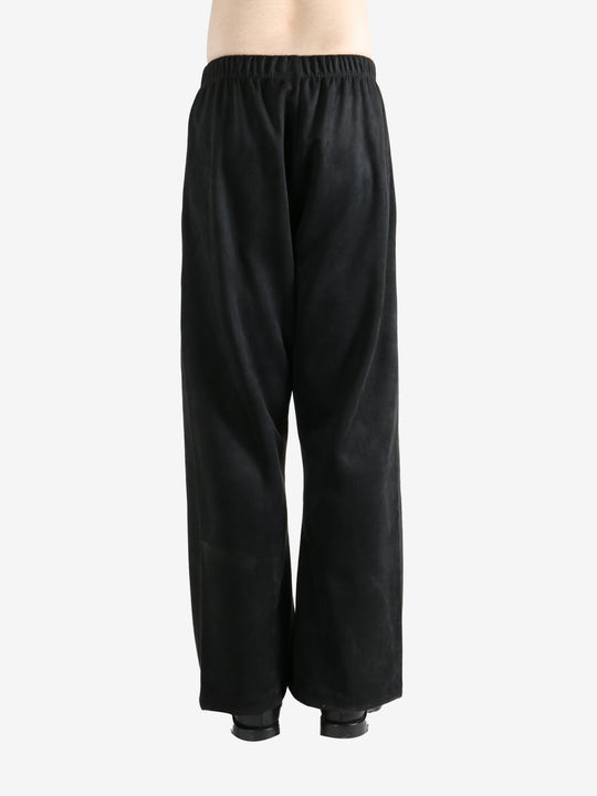 Black pants worn by a person, showing the pants fit