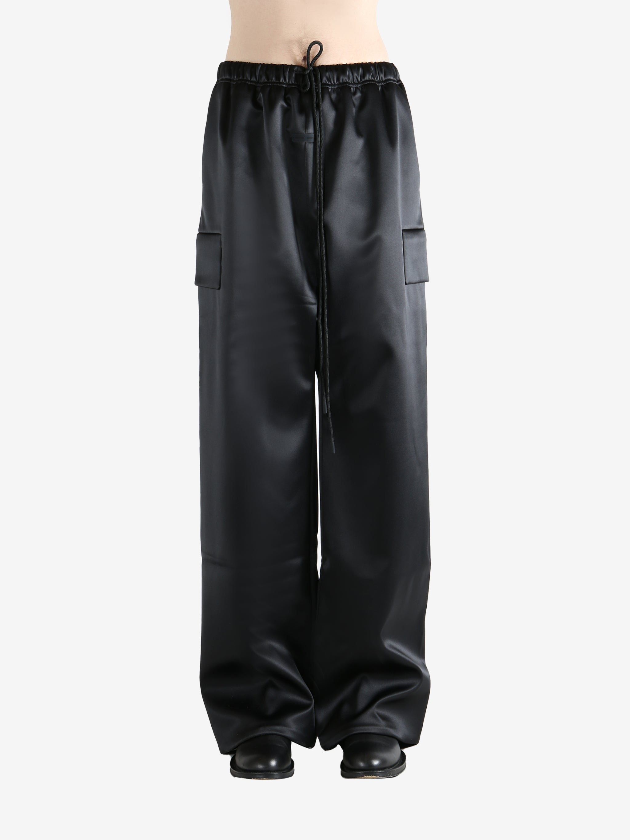 Black pants worn by a person, showing the pants fit