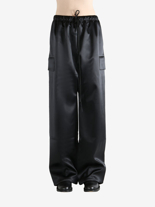 Black pants worn by a person, showing the pants fit