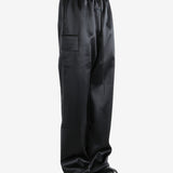 Black pants worn by a person, showing the pants fit